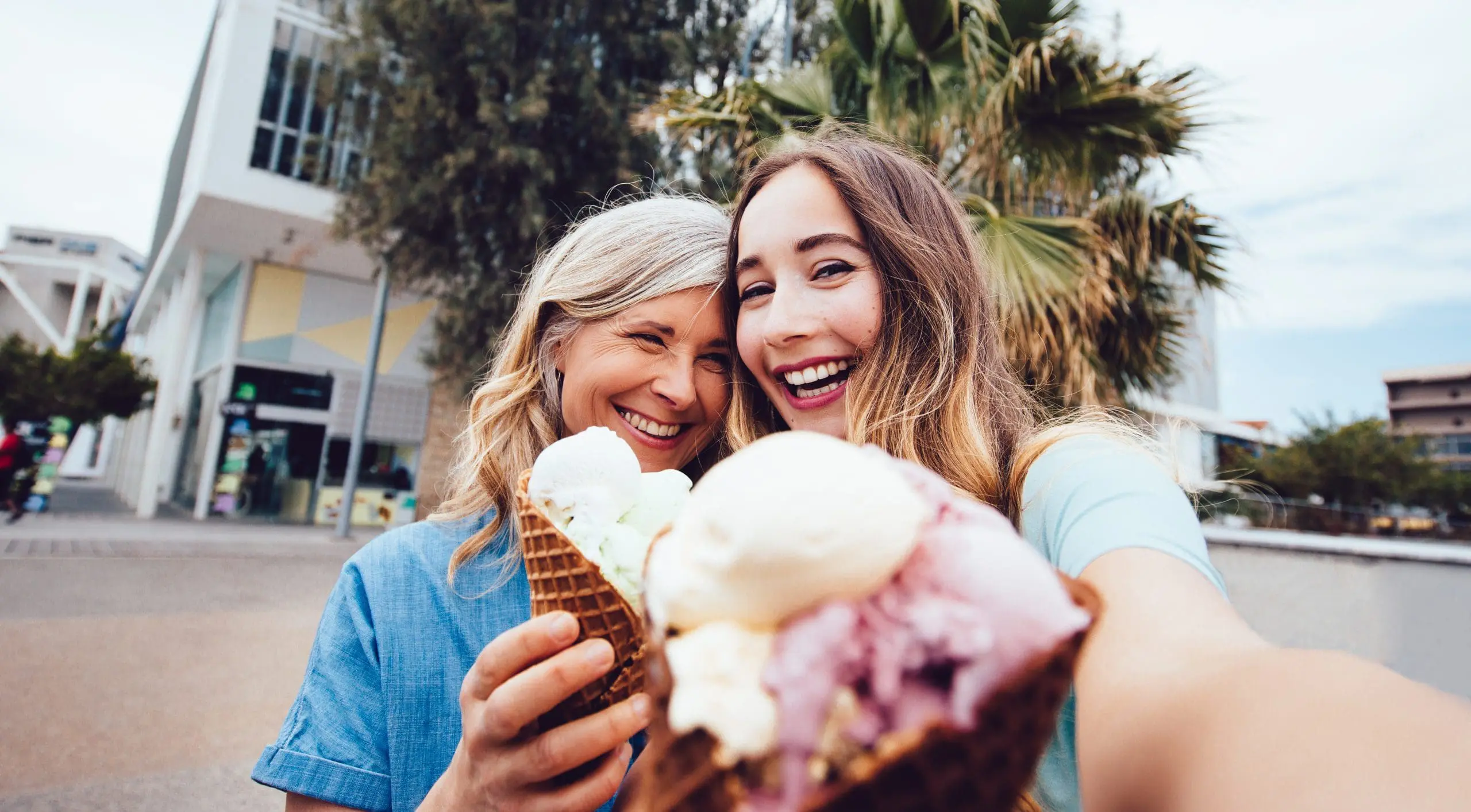 Young millennial woman poses for a selfie with her grandmother.