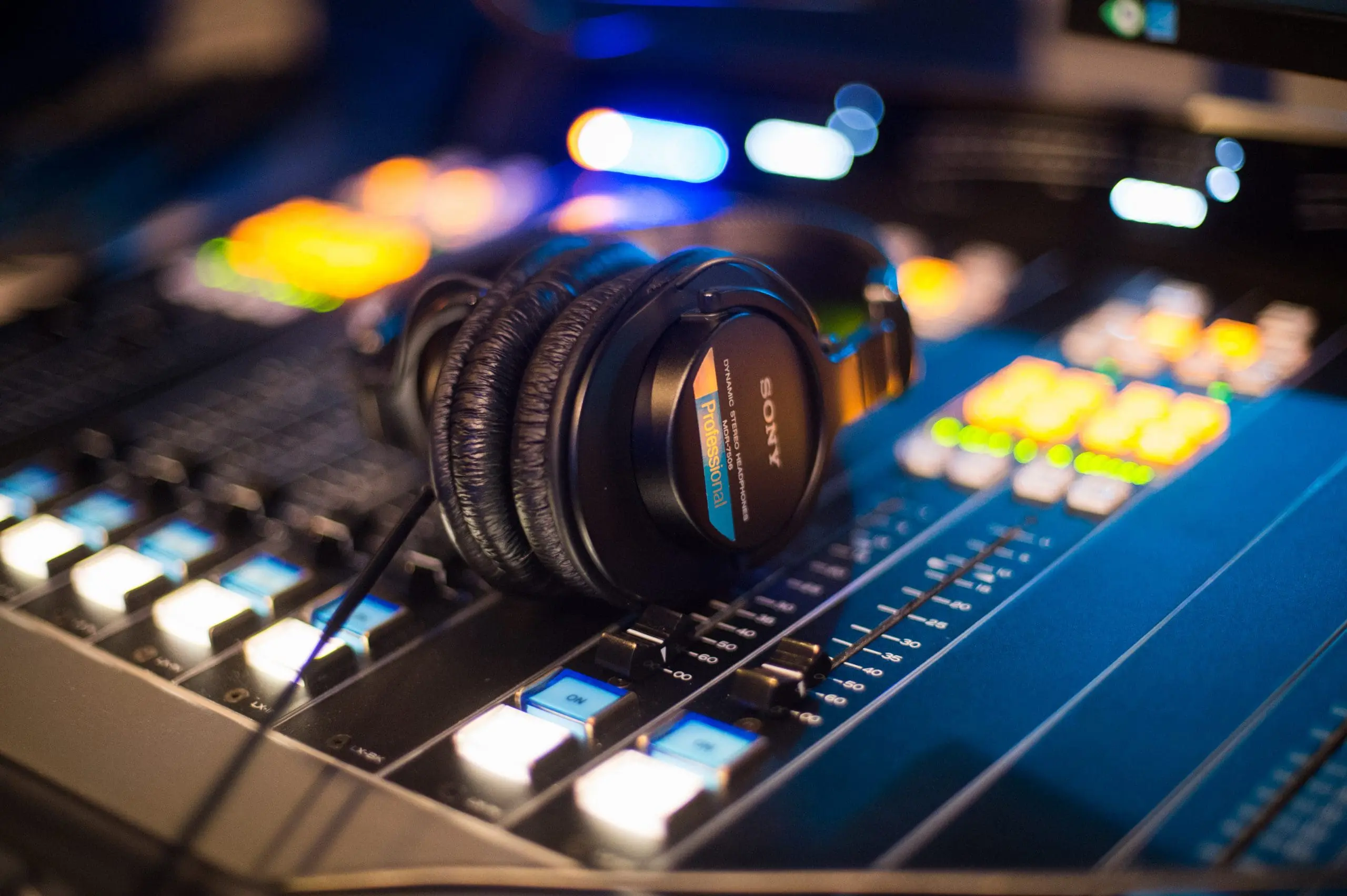 Headphones rest on the control panel inside one of Impact Partnership's ten in-house radio studios