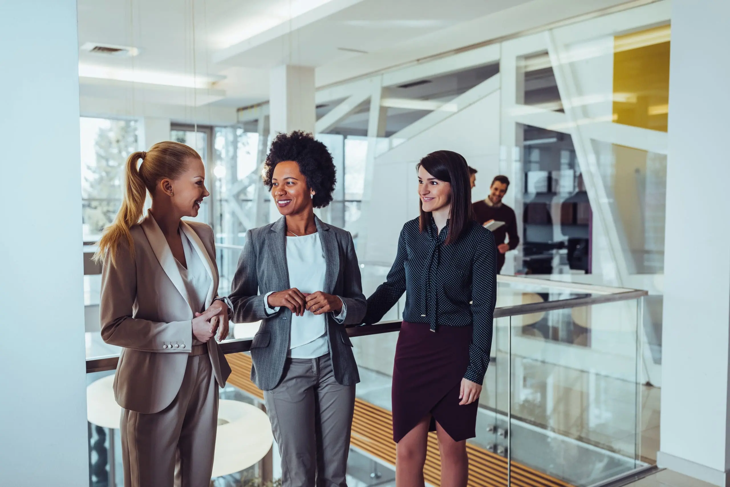Female financial advisors talking in a stairwell.