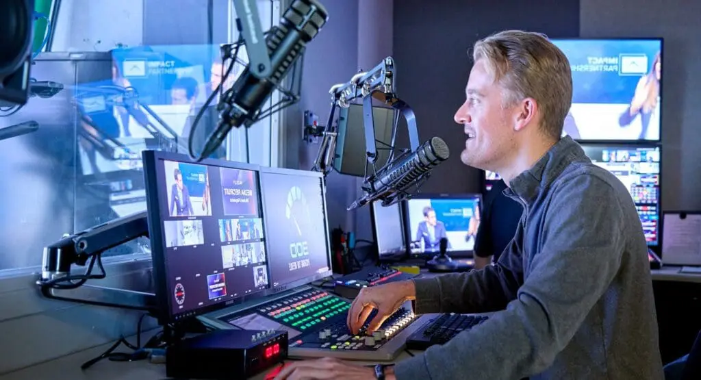 Impact Partnership employee in the TV studio at our offices