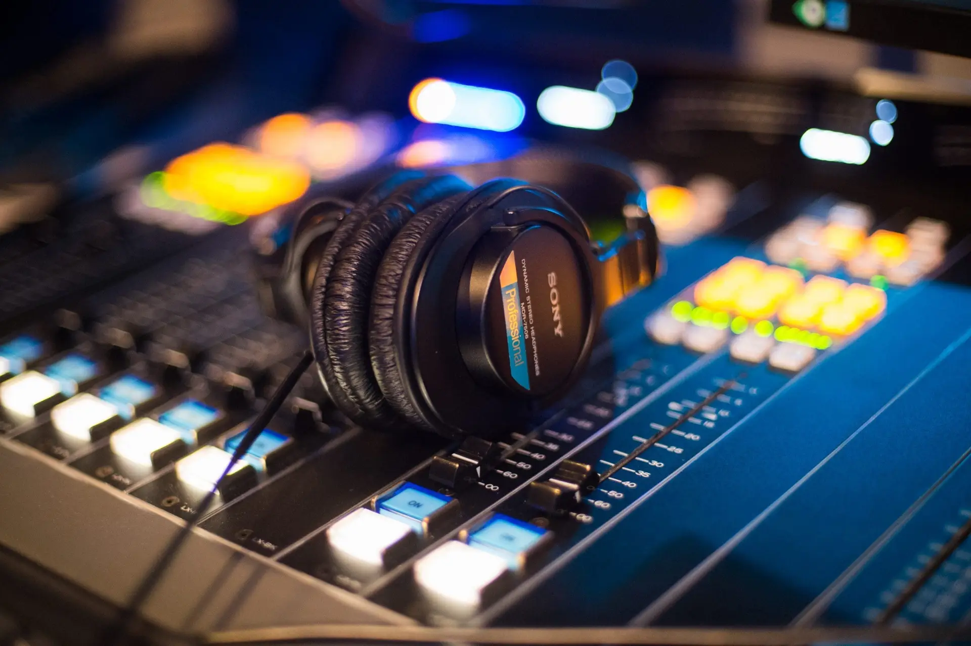 Headphones rest on the control panel inside one of Impact Partnership's ten in-house radio studios