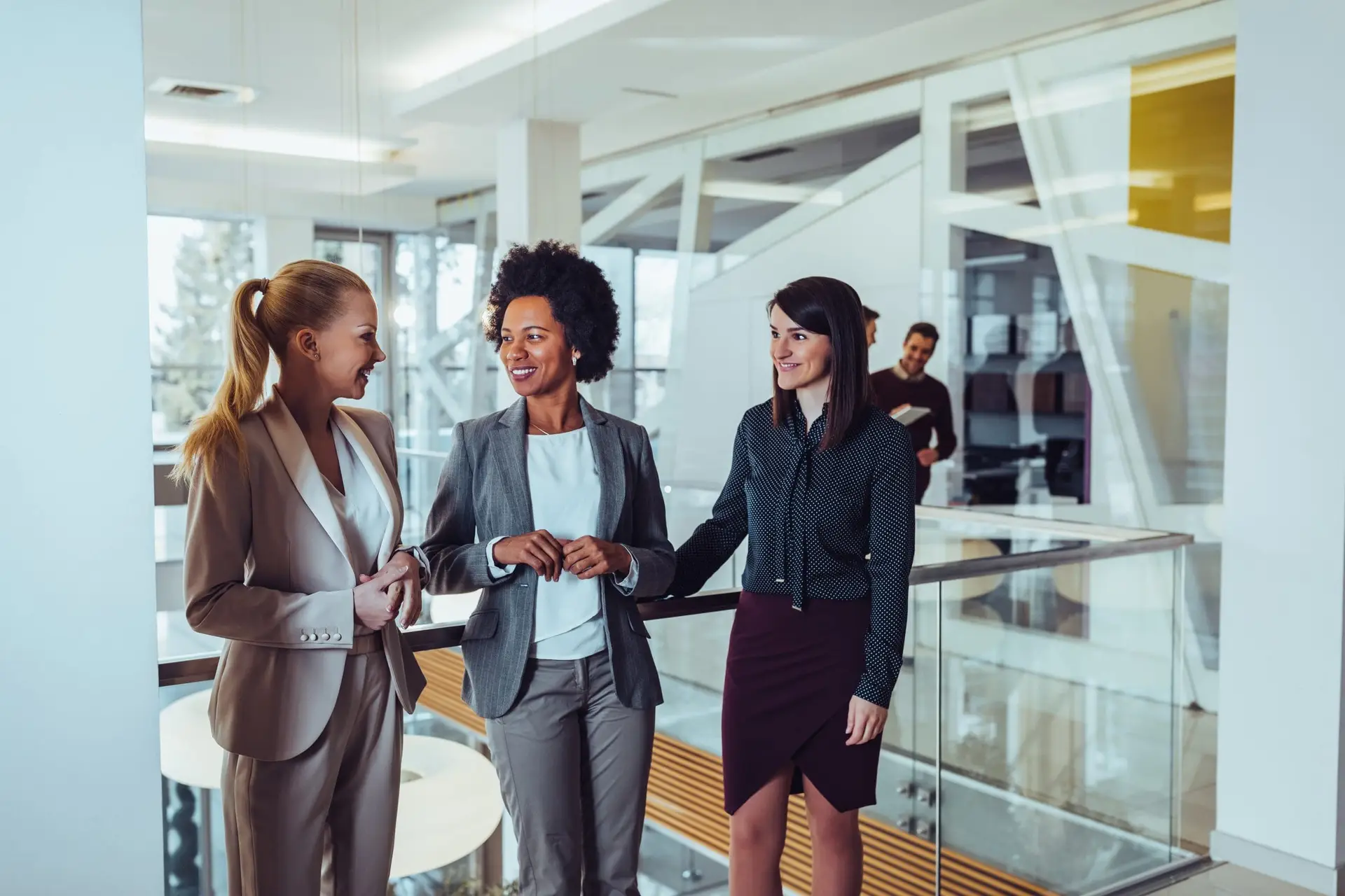 Female financial advisors talking in a stairwell.