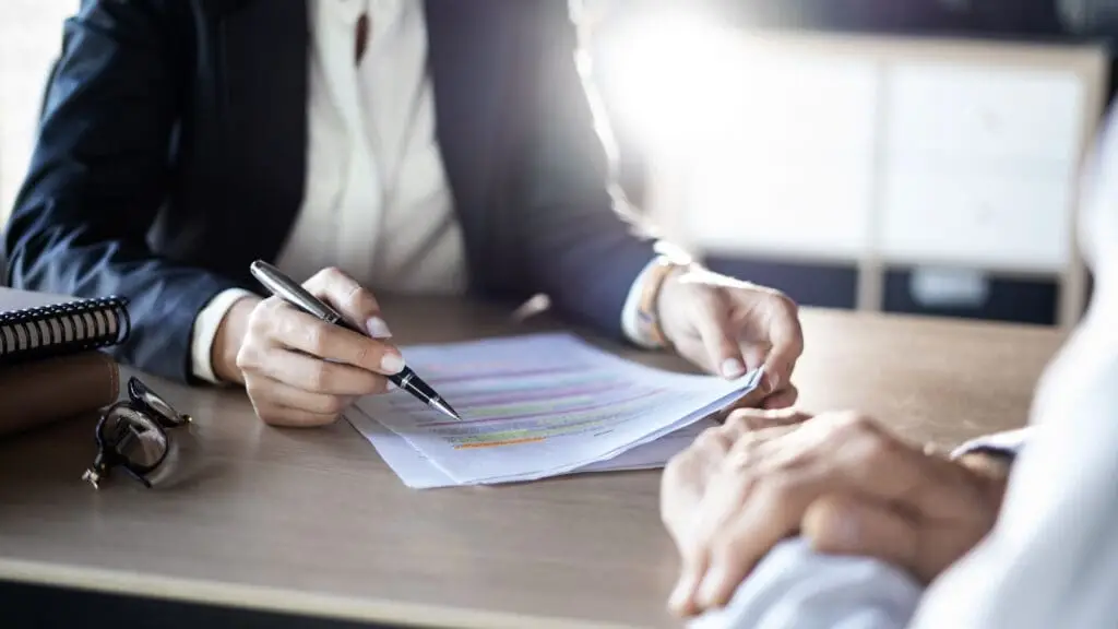 Financial advisor working with client on documents
